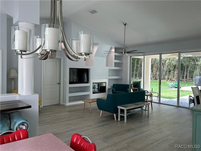 5774 N Lamp Post Dr, Beverly Hills, FL 34465 - living area with wood finished floors, built in features, a ceiling fan, and high vaulted ceiling