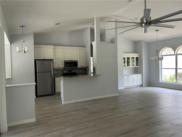 5774 N Lamp Post Dr, Beverly Hills, FL 34465 - kitchen featuring appliances with stainless steel finishes, a chandelier, ceiling fan, white cabinets, and high vaulted ceiling
