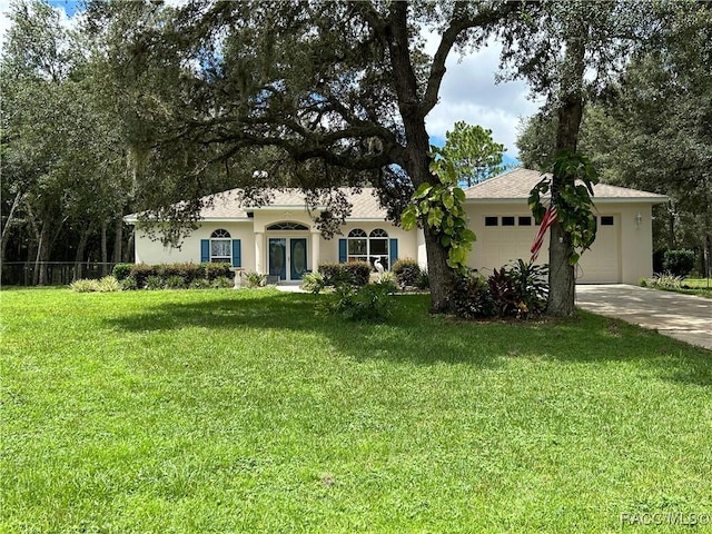5774 N Lamp Post Dr, Beverly Hills, FL 34465 - view of front facade with a garage, driveway, and stucco siding