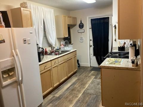 1408/1410 NE 15th Pl, Ocala, FL 34470 - kitchen with white fridge with ice dispenser, dark wood-style flooring, light countertops, and stove
