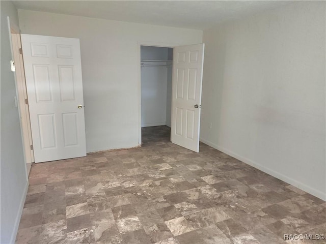 1408/1410 NE 15th Pl, Ocala, FL 34470 - unfurnished bedroom with baseboards and a closet