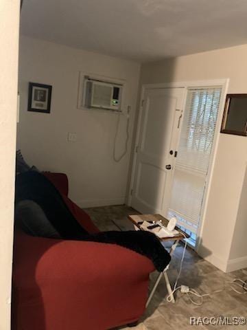 1408/1410 NE 15th Pl, Ocala, FL 34470 - living room featuring an AC wall unit and baseboards