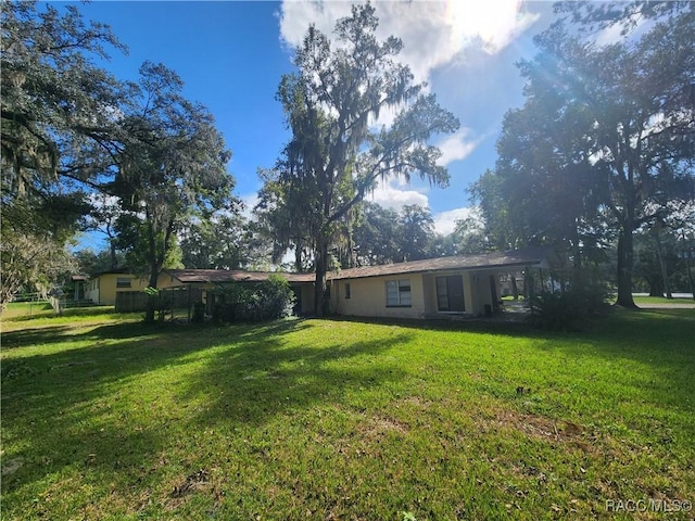 1408/1410 NE 15th Pl, Ocala, FL 34470 - rear view of house with a lawn