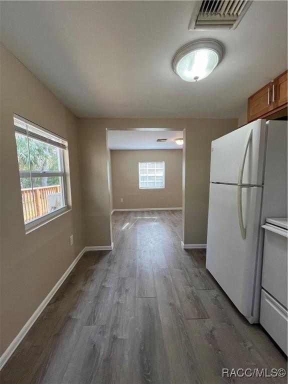 kitchen featuring dark hardwood / wood-style floors and white appliances