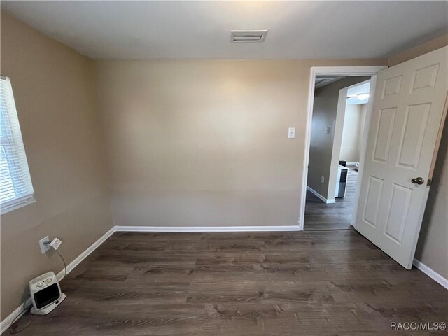 spare room with dark hardwood / wood-style floors