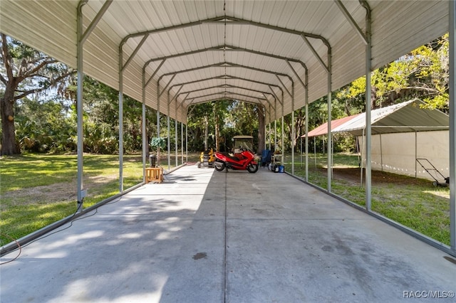 view of vehicle parking with a carport and a lawn