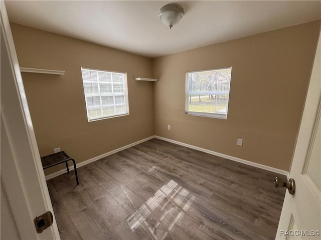 spare room featuring dark wood-type flooring