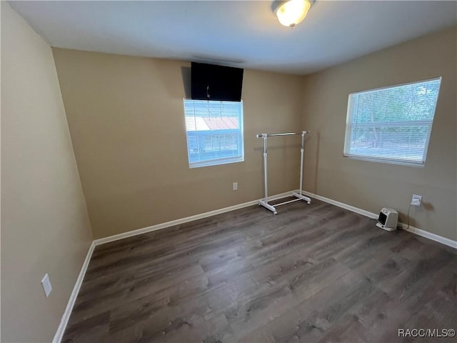 unfurnished room featuring dark wood-type flooring