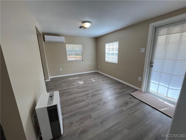 entryway featuring dark hardwood / wood-style floors and a wall mounted air conditioner