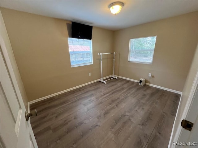 clothes washing area with dark hardwood / wood-style flooring