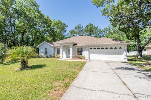 ranch-style home featuring a garage, stucco siding, concrete driveway, and a front lawn