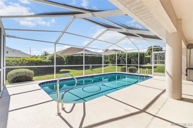 view of swimming pool with a lawn, a lanai, and a patio area