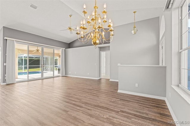 interior space with hardwood / wood-style flooring, ceiling fan with notable chandelier, and high vaulted ceiling