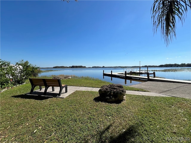 dock area featuring a water view and a yard