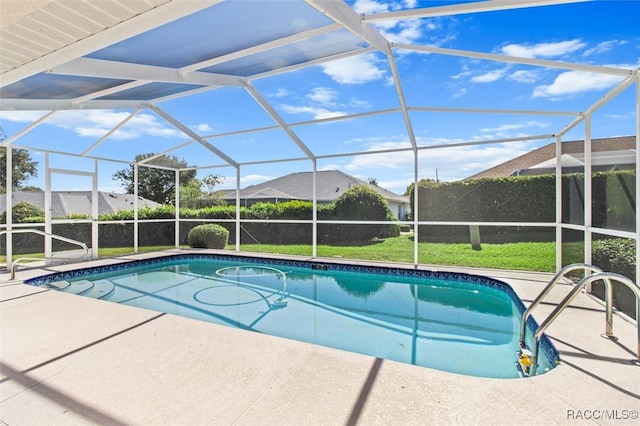 view of pool with a lawn, a lanai, and a patio