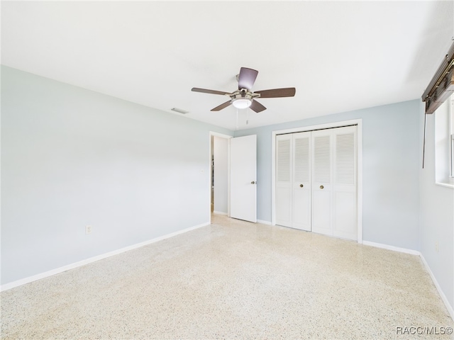 1080 N Hollywood Cir, Crystal River, FL 34429 - unfurnished bedroom with dark aggregate flooring, baseboards, a closet, and ceiling fan