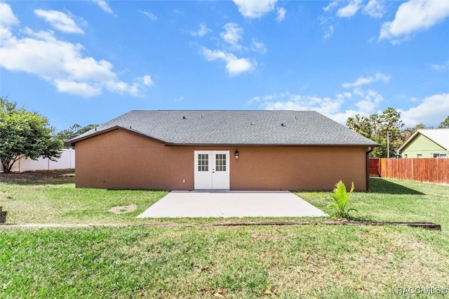 back of property featuring a lawn and a patio