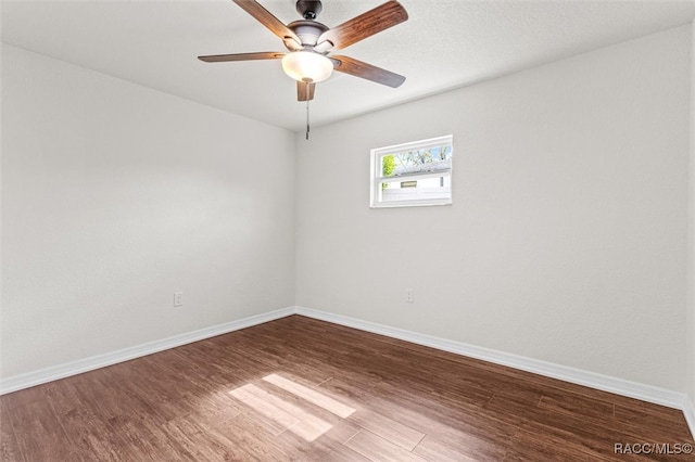 empty room with hardwood / wood-style floors and ceiling fan