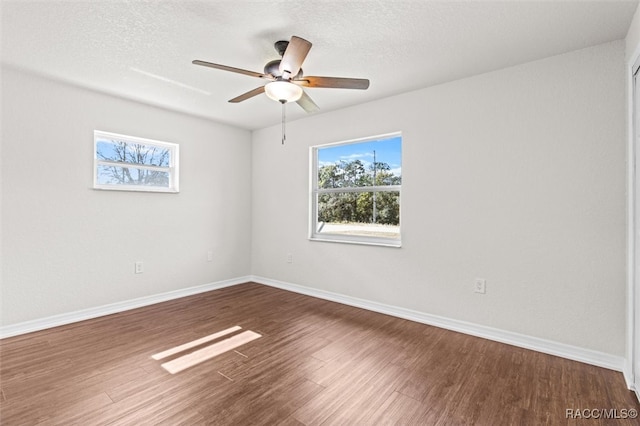 spare room featuring hardwood / wood-style floors, ceiling fan, and a textured ceiling