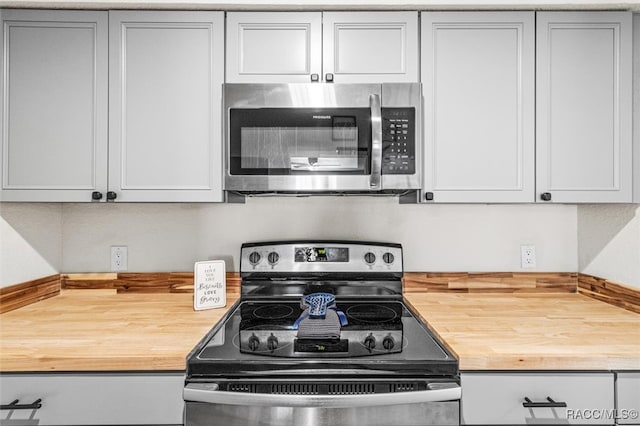 kitchen featuring wood counters and appliances with stainless steel finishes