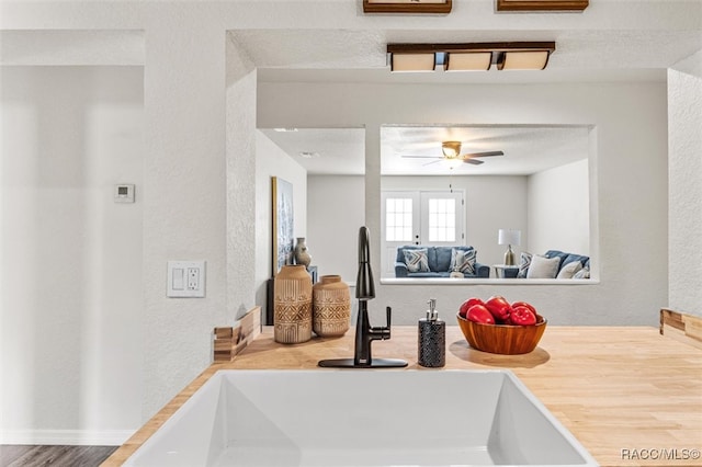 interior space with ceiling fan, sink, and french doors