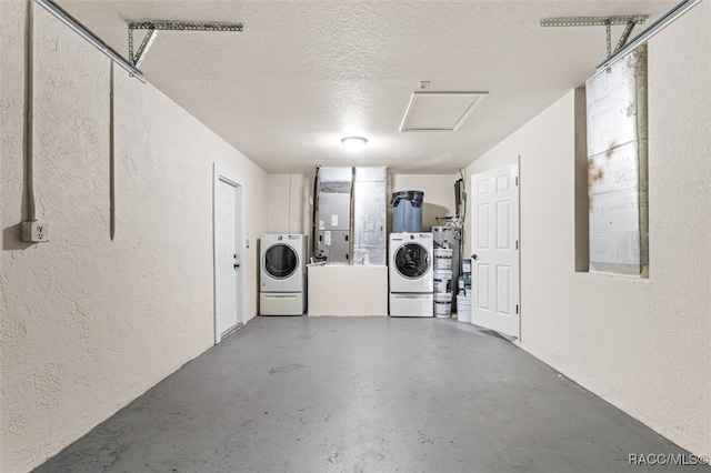 garage featuring secured water heater and washing machine and clothes dryer