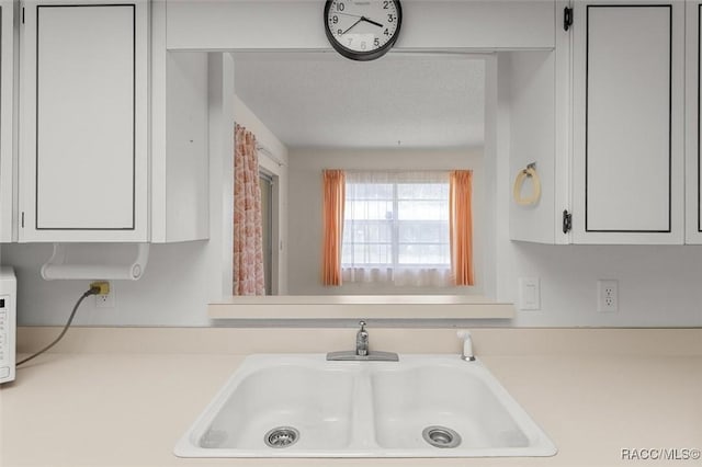 732 Wharton Ter, Inverness, FL 34450 - kitchen view of light countertops, white cabinetry, and white microwave
