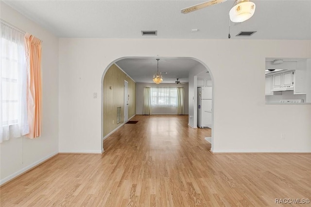 732 Wharton Ter, Inverness, FL 34450 - empty room featuring arched walkways, light wood-type flooring, and ceiling fan
