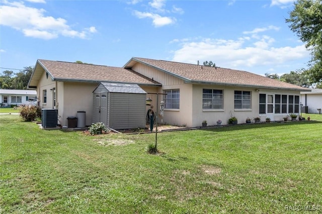 732 Wharton Ter, Inverness, FL 34450 - back of property with a lawn, stucco siding, a storage unit, and a shingled roof