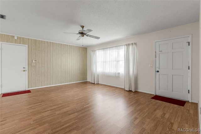 732 Wharton Ter, Inverness, FL 34450 - entrance foyer featuring a ceiling fan, wood finished floors, a textured ceiling, and wooden walls
