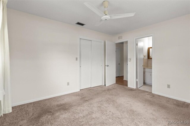 732 Wharton Ter, Inverness, FL 34450 - unfurnished bedroom with carpet, a closet, connected bathroom, and ceiling fan