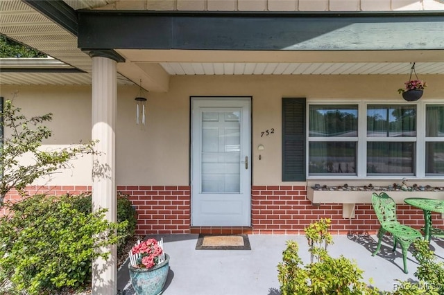 732 Wharton Ter, Inverness, FL 34450 - entrance to property featuring brick siding, stucco siding, and a porch