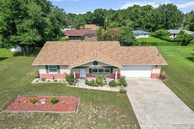 732 Wharton Ter, Inverness, FL 34450 - ranch-style house with an attached garage, brick siding, driveway, and a front lawn