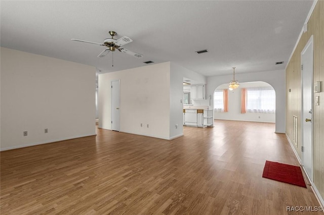 732 Wharton Ter, Inverness, FL 34450 - unfurnished living room featuring ceiling fan, arched walkways, and light wood-style floors