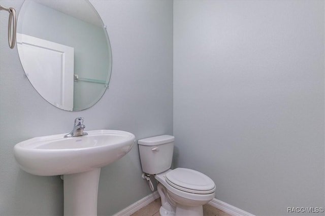 483 W Runyon Loop, Beverly Hills, FL 34465 - half bath featuring baseboards, toilet, tile patterned floors, and a sink