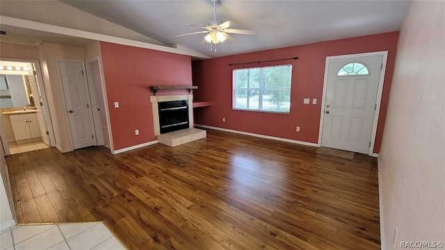 unfurnished living room with ceiling fan, lofted ceiling, and hardwood / wood-style flooring