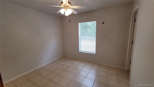 tiled spare room with ceiling fan