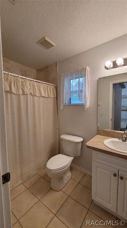 bathroom with vanity, tile patterned flooring, a shower with shower curtain, toilet, and a textured ceiling