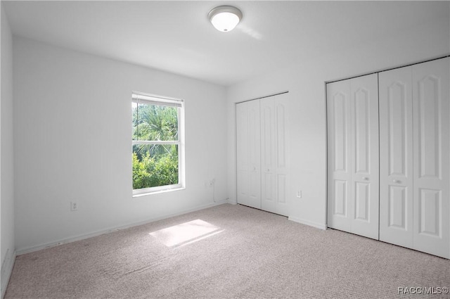 604 Morse St, Inverness, FL 34452 - unfurnished bedroom with two closets, carpet floors, and baseboards