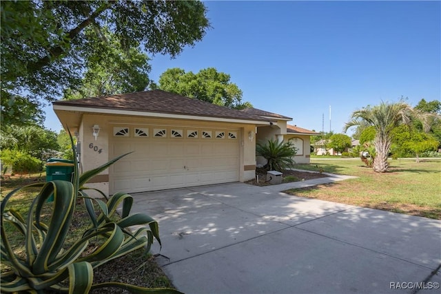604 Morse St, Inverness, FL 34452 - view of front of house featuring stucco siding, driveway, a front lawn, and an attached garage