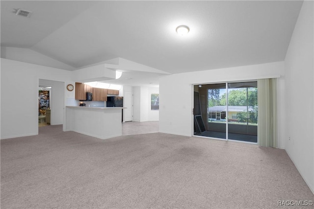 604 Morse St, Inverness, FL 34452 - unfurnished living room with light colored carpet, vaulted ceiling, and baseboards