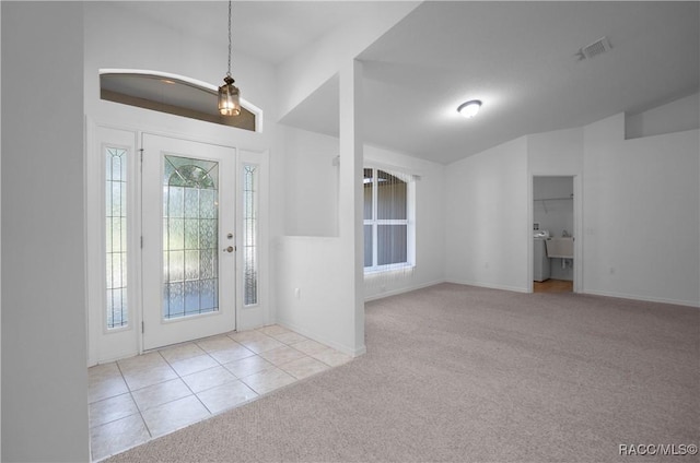 604 Morse St, Inverness, FL 34452 - entryway with carpet floors, tile patterned flooring, baseboards, and vaulted ceiling