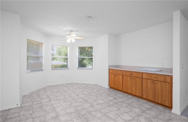 604 Morse St, Inverness, FL 34452 - kitchen with light countertops, a ceiling fan, and baseboards