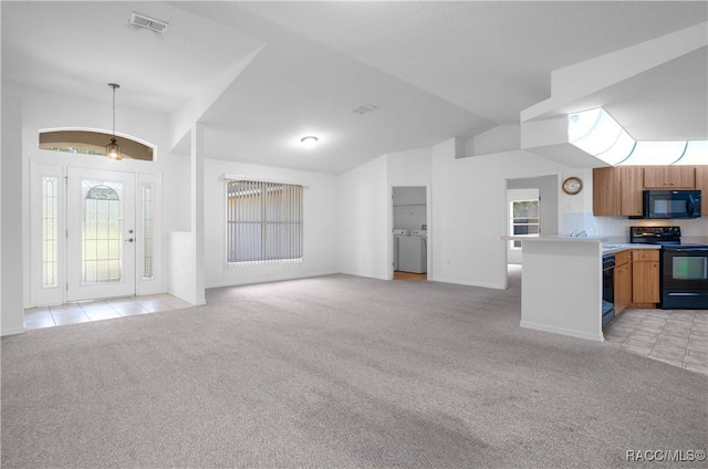 604 Morse St, Inverness, FL 34452 - unfurnished living room featuring light carpet, washing machine and clothes dryer, vaulted ceiling, light tile patterned flooring, and healthy amount of natural light
