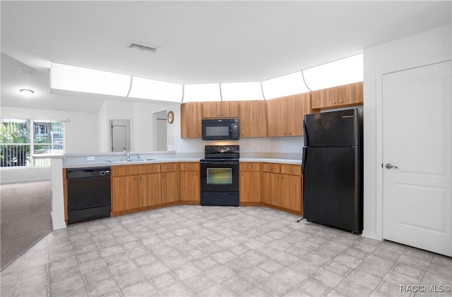 604 Morse St, Inverness, FL 34452 - kitchen featuring black appliances, light countertops, a sink, and a peninsula