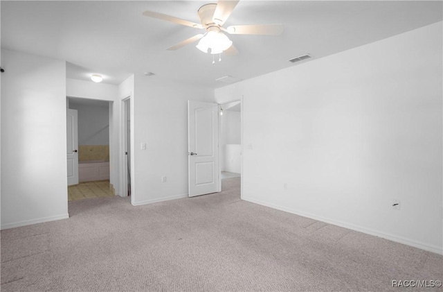 604 Morse St, Inverness, FL 34452 - unfurnished bedroom with light carpet, baseboards, ensuite bathroom, and a ceiling fan