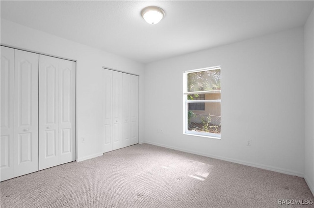 604 Morse St, Inverness, FL 34452 - unfurnished bedroom with multiple closets, carpet flooring, and baseboards