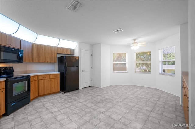 604 Morse St, Inverness, FL 34452 - kitchen with black appliances, light countertops, ceiling fan, baseboards, and brown cabinetry