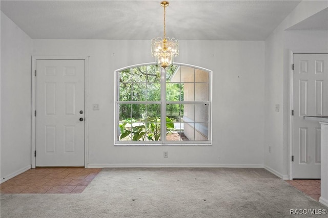 unfurnished dining area featuring an inviting chandelier, carpet floors, tile patterned flooring, and baseboards