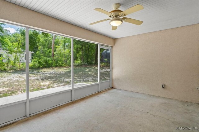spare room featuring ceiling fan and concrete flooring